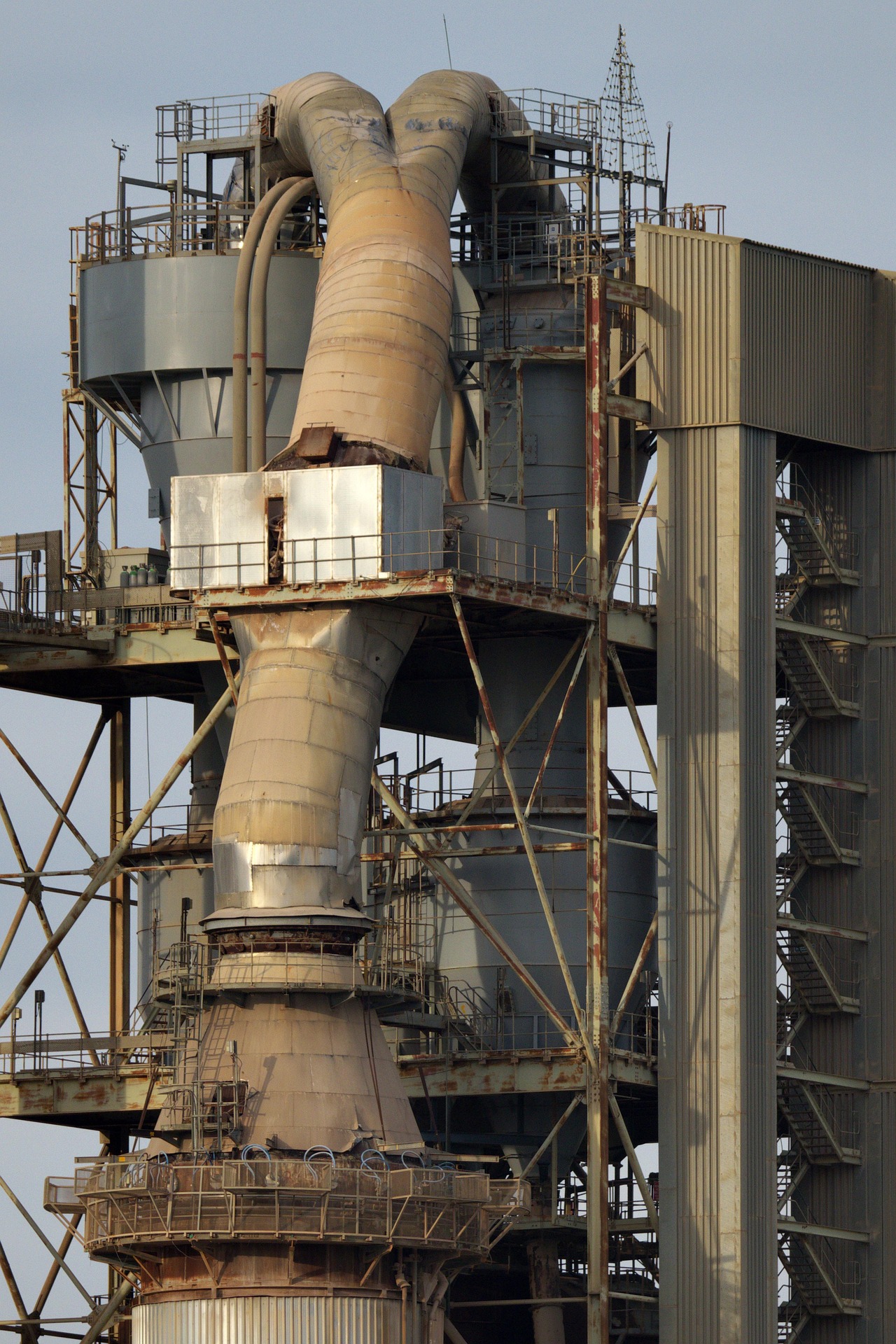 Large cement manufacturing plant with industrial processing and material handling systems.