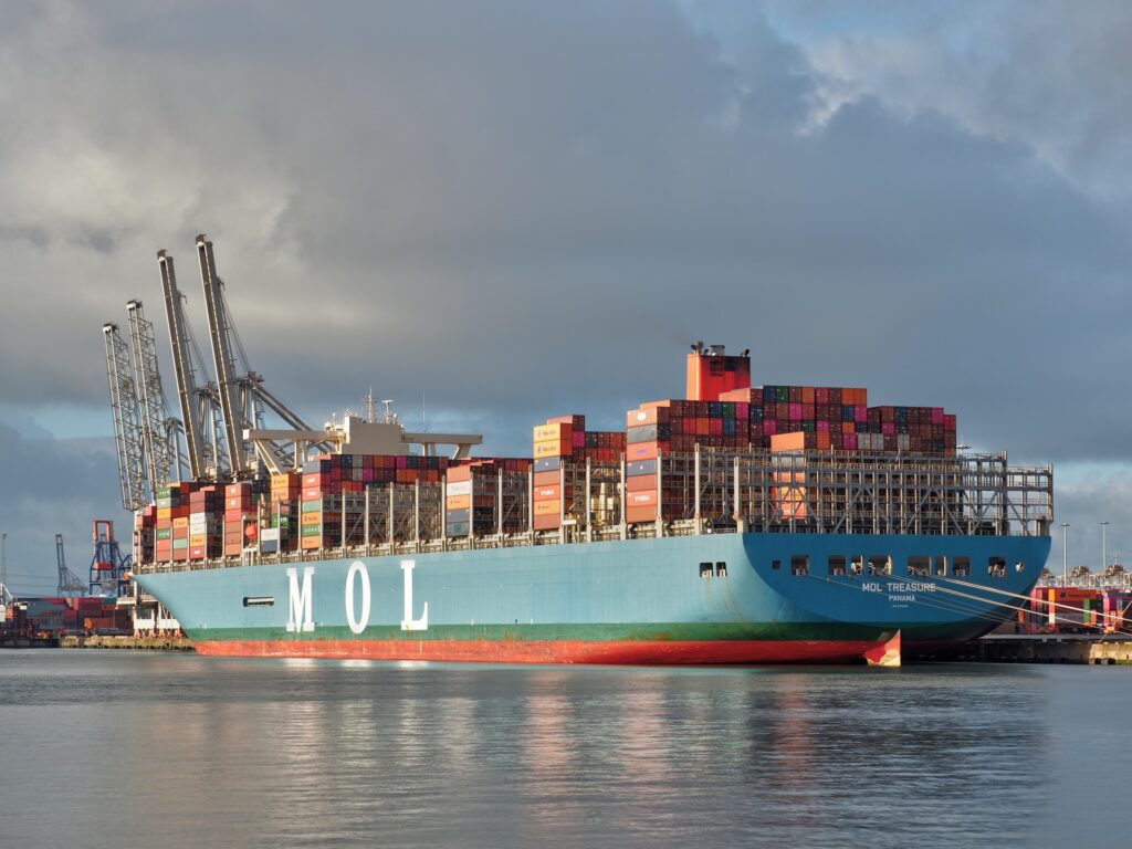 Container vessel docked at a commercial port handling international cargo operations.